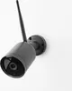 A black outdoor security camera with an antenna is mounted on a white wall. Podgląd zdjęcia produktu