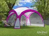 A pink and white event pavilion set up on a grassy lawn with trees in the background. Produktbild-Vorschau