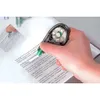 A hand is using a correction tape dispenser on a document. Produktbild-Vorschau