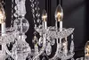 A close-up view of a crystal chandelier with illuminated bulbs. Náhled obrázku produktu