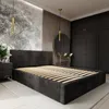A modern bedroom with a dark upholstered bed frame and a large circular mirror. Podgląd zdjęcia produktu