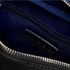 A close-up view of the interior of a black bag, showing a zipper and a black leather label with the Lacoste logo. Anteprima dell’immagine prodotto