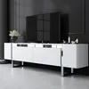 A modern white TV stand with silver accents and metal legs, placed in a minimalist room with a black wall and white floor. Voir les images du produit