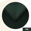A close-up circular view of dark green fabric, folded. Anteprima dell’immagine prodotto