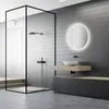 A modern bathroom with a glass-enclosed shower, a floating vanity with a sink, and a backlit round mirror. Anteprima dell’immagine prodotto