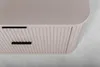 A close-up view of a beige matte cabinet with ribbed detailing and black drawer pulls. Anteprima dell’immagine prodotto