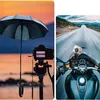 A split image showing a camera setup with an umbrella on a beach and a GoPro mounted on a motorcycle dashboard. Produktbild-Vorschau
