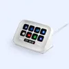 A white Elgato Stream Deck Neo device with illuminated buttons is shown on a light gray background. Náhled obrázku produktu