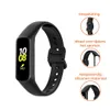 A black silicone watch strap for a Samsung Galaxy Fit 2 is shown with close-up images highlighting its features and material. Produktbild-Vorschau