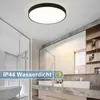 A modern bathroom with a ceiling light, sinks, and mirrors. Produktbild-Vorschau