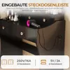 A close-up view of a black vanity table with a hairdryer plugged into an integrated power strip. Produktbild-Vorschau