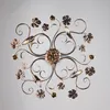A ceiling light fixture with a floral and vine design, viewed from directly above. Podgląd zdjęcia produktu