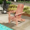 An Adirondack chair placed on a patio next to a swimming pool. Produktbild-Vorschau