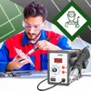 A man is working on a circuit board with a soldering iron, with a hot air rework station in the foreground. A graphic of a welder is in the background. Produktbild-Vorschau