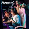 A group of young adults are excitedly playing a video game, with one person sitting in a pink gaming chair. Produktbild-Vorschau