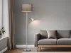 A floor lamp with a reading light next to a sofa in a living room. Anteprima dell’immagine prodotto