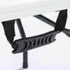 A close-up view of a black handle and strap attached to a white surface, likely a folding table. Voir les images du produit
