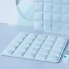 A light blue cooling mat for pets is shown on a light blue surface, with a blurred background of light blue shapes. Produktbild-Vorschau