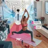 A woman doing yoga in a living room with a fan Náhled obrázku produktu
