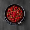 A chocolate cake with raspberries and chocolate shavings in a springform pan, placed on a dark surface. Produktbild-Vorschau