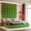 A bedroom scene featuring a green upholstered bed with a matching headboard and bedding. Anteprima dell’immagine prodotto