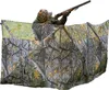 A person is using a camouflage hunting blind. Produktbild-Vorschau