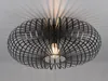 A black, wireframe pendant light fixture with a visible bulb, casting shadows on a white ceiling. Voir les images du produit