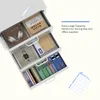 A white 3-drawer filing cabinet shown from a diagonal angle with its drawers partially open. Items inside include headphones, notebooks, envelopes, and binders. Text overlay describes the product's capacity. Náhled obrázku produktu