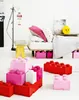 A child's bedroom with LEGO-themed storage boxes and bedding. Voir les images du produit