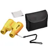 A set of yellow and orange binoculars with a black carrying case and a cleaning cloth, laid out on a white background. Produktbild-Vorschau