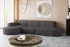A modern living room with a sectional sofa, coffee table, and wall art.