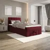 A bedroom scene featuring a burgundy boxspring bed. Produktbild-Vorschau