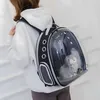 A person wearing a white hoodie and dark pants is carrying a black and clear pet carrier backpack with a cat inside. Voir les images du produit