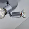 A close-up view of a silver-colored ceiling spotlight with two adjustable heads, one of which contains an LED bulb and the other a GU10 bulb. Voir les images du produit