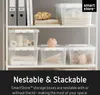 Shelving unit with various storage boxes and office supplies. Produktbild-Vorschau