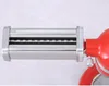 A close-up side view of a pasta roller attachment for a red stand mixer. Náhled obrázku produktu