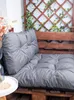A close-up view of grey pallet cushions on a wooden pallet bench, with a decorative lattice and string lights in the background. Produktbild-Vorschau