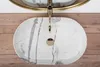 A top-down view of a marble sink with a gold faucet. Náhľad obrázku produktu
