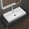 A modern white rectangular basin with a chrome faucet is mounted on a dark countertop, with a large illuminated mirror above it. The background shows a dark gray wall and a wooden floor. Produktbild-Vorschau