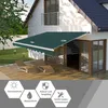 A green awning is extended over a patio area outside a house, with lounge chairs on the wooden deck. Voir les images du produit