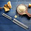 A grater with cheese on a wooden board, set against a blue wooden background. Produktbild-Vorschau