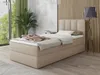 A bedroom scene featuring a beige boxspring bed with bedding and a headboard, next to a large window with green curtains and a potted plant. A floor lamp stands to the right. Produktbild-Vorschau