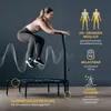 A woman is jumping on a fitness trampoline, with text overlays highlighting features. Voir les images du produit