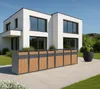 A modern white house with a row of trash bins in front of it. Produktbild-Vorschau