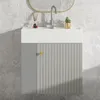 A modern bathroom vanity with a ribbed gray door and a gold knob, set against a gray tiled wall. Podgląd zdjęcia produktu