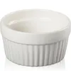 A white ceramic ramekin dish with fluted sides is shown against a white background. Produktbild-Vorschau