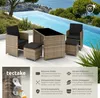 A rattan furniture set with black cushions is placed on a patio next to a swimming pool. Produktbild-Vorschau