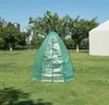 A green greenhouse tent is set up on a grassy lawn with trees and buildings in the background. Náhľad obrázku produktu