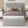 A bed with bedding and pillows in a bedroom setting. Anteprima dell’immagine prodotto
