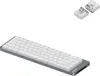 A silver and white Lofree Flow 2 68 mechanical keyboard is shown on a white background. Two small white components, possibly keycaps or switches, are visible in the upper right corner. Produktbild-Vorschau